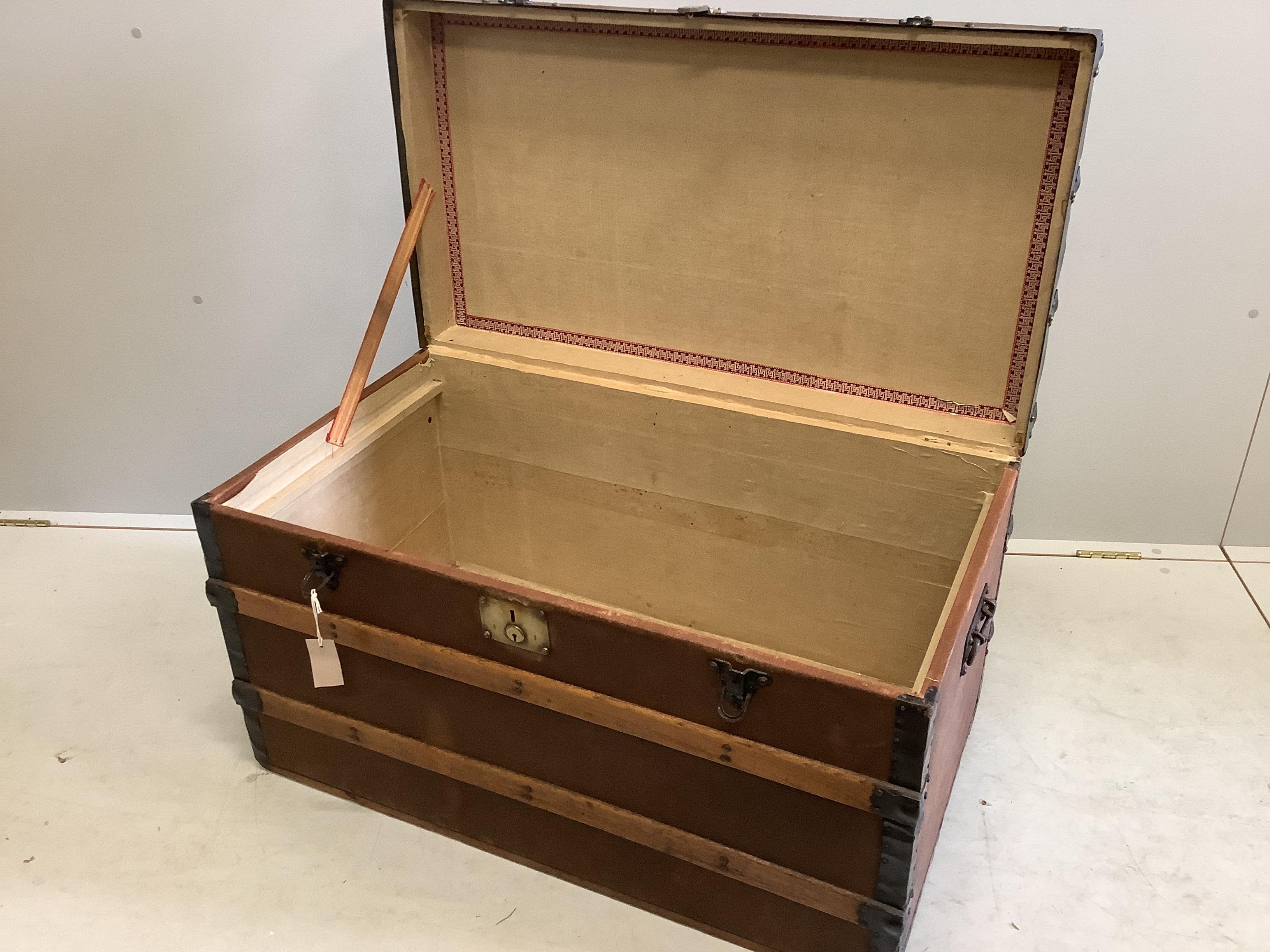 An early 20th century studded canvas covered travelling trunk, width 92cm, depth 50cm, height 53cm